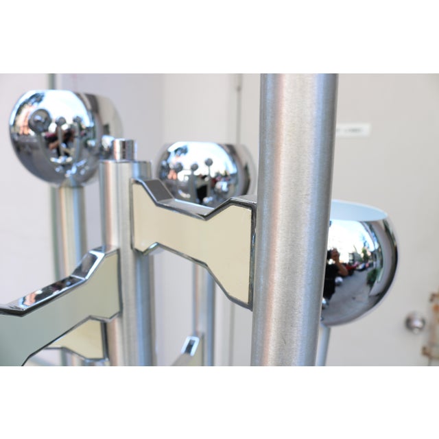 Modernist twelve light floor lamp. Chrome plated with six protruding arms with an up and down light on each arm. Mounted...