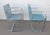 2 Brno style chairs (designed by Ludwig Mies van der Rohe) with flat arm silver tone metal and blue fabric. The chairs are...