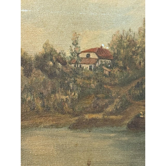A vintage original landscape oil painting on canvas depicting a quiet waterfront scene with a distant cottage, wooded...