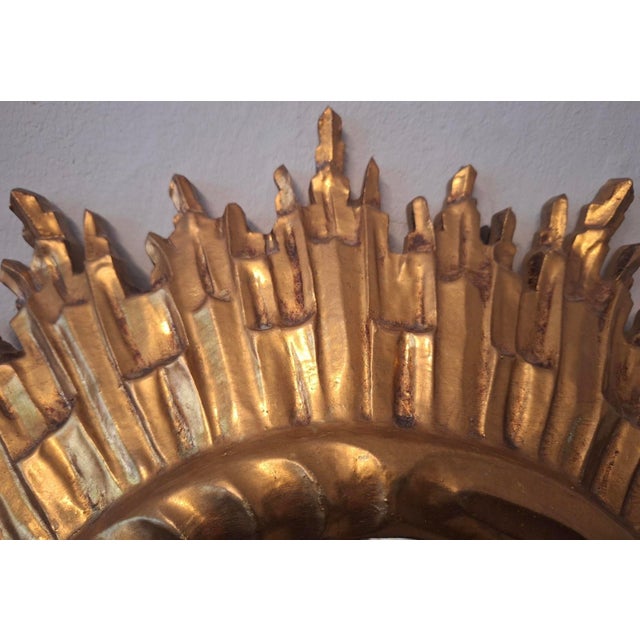 Gilded mid century circular wall mirror with a sunburst design, Italy 1960s.