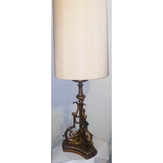 Mid century Spanish Revival style gilt gothic iron table lamp with shade. Shade is meticulous with gold trimming around...