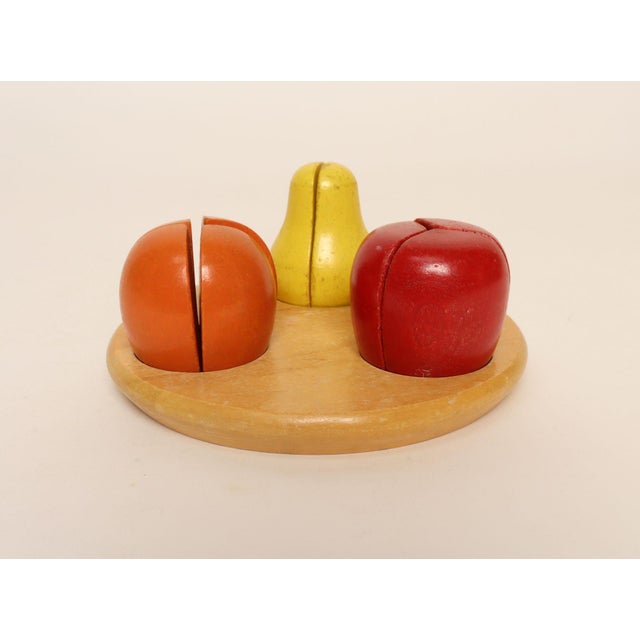 Creative Playthings wooden fruit puzzle, ca. late 1960s/early 1970s, USA. Composed of four orange pieces, three apple, and...