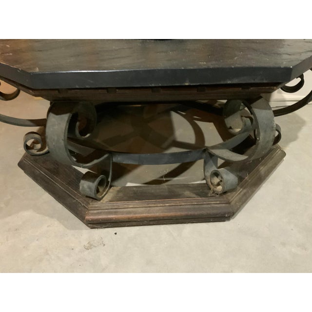 Vintage Mid Century Slate table. It is in an octagonal shape. The Wrought Iron and wood base are sturdy in design....
