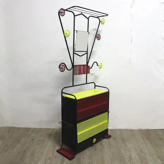 This colorful, partially perforated metal wardrobe was designed during the 1950s and manufactured in France. It features a...