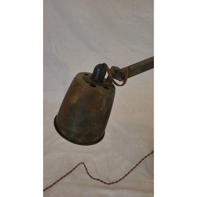 This is a great vintage factory floor desk lamp. Very adjustable with a vice focused light. Base is made of wood block...