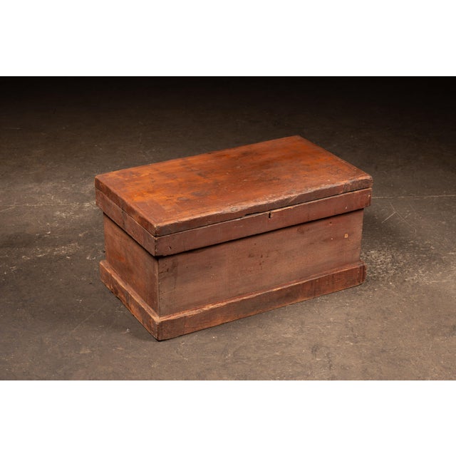 Rectangular pine blanket chest with a hinged lid and applied base molding, constructed with exposed hand-cut dovetail...