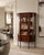 An antique Edwardian mahogany inlaid display cabinet with bowed glass ends, decorative astragal glazing and an elegant...