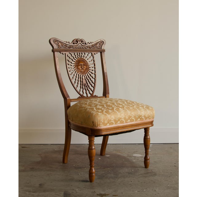 A striking side or slipper chair with a pierced back splat carved as a radiant sun. The serpentine crest rail is carved...