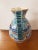 This is a Circa 1970 Italian Deruta Ware Faience Pottery Stamped Pitcher, Made in Italy. It measures 14 3/8" high, 9 1/2"...
