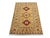 This Kazak style wool rug has three bold medallions across a golden beige field. Burgundy, cream, soft pink, and blue...