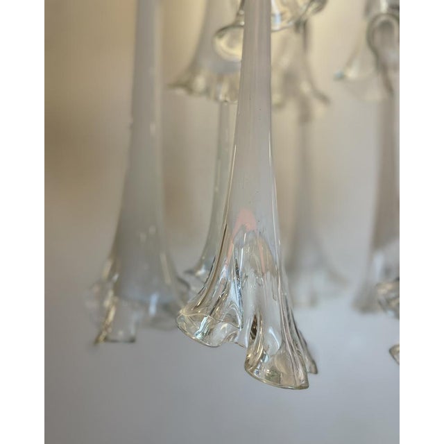 Astonishing and beautiful ceiling lamp composed of 13 lilies made of white and clear murano glass hung on a chromed...