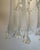 Astonishing and beautiful ceiling lamp composed of 13 lilies made of white and clear murano glass hung on a chromed...