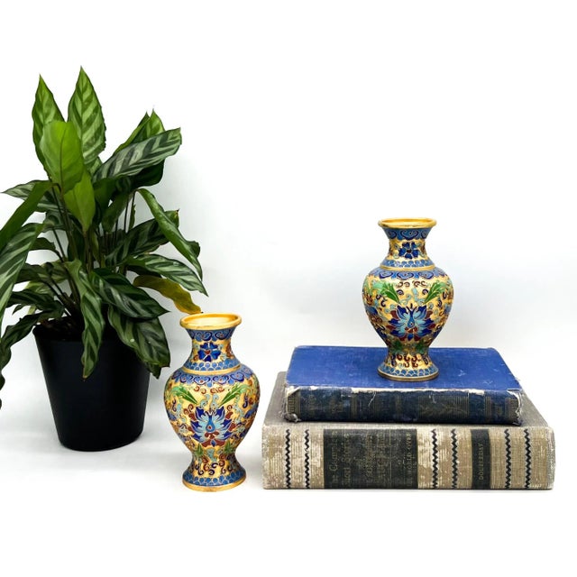 A dazzling pair of diminutive, mid-century Chinese cloisonné vases showcasing intricate hand-enameled lotus blossoms and...