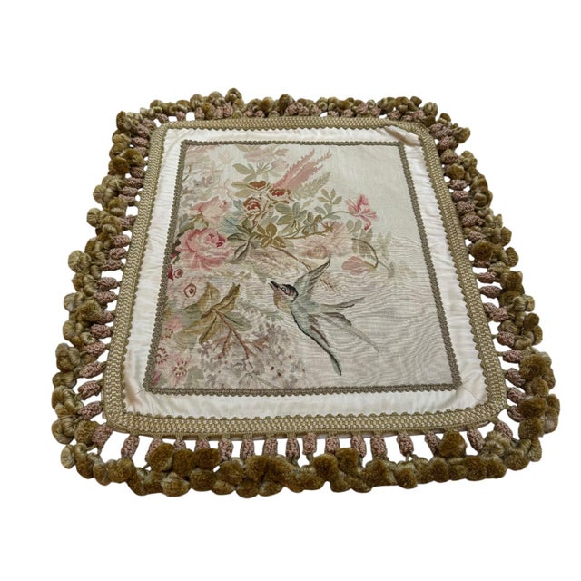 A beautifully detailed silk tapestry cushion cover featuring a delicate floral composition with a graceful bird in flight....