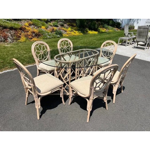 Mid Century Rattan Dining Set with Six Chairs. Amazing cobweb designed back to these sculptural chairs. Covered in a...