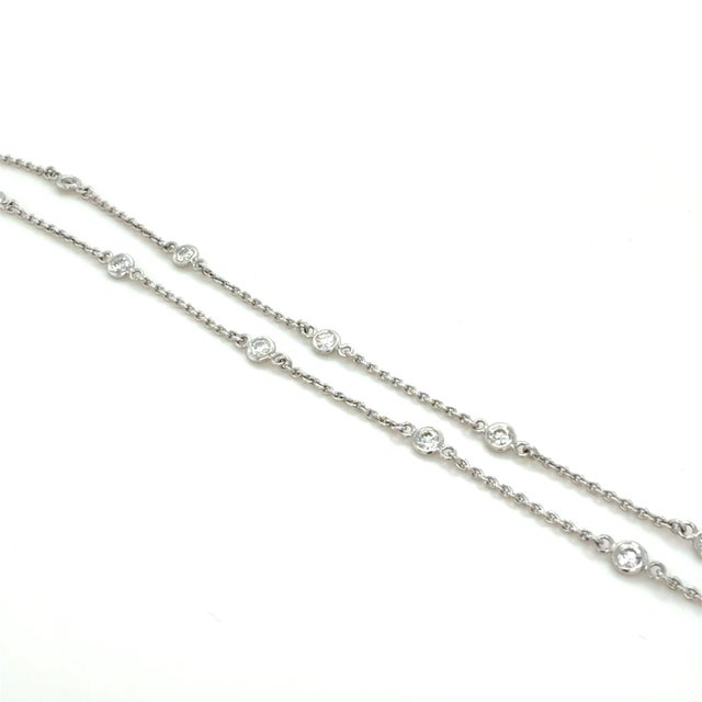 This classic station necklace by Roberto Coin contains 19 bezel set round brilliant cut diamonds weighing approximately...