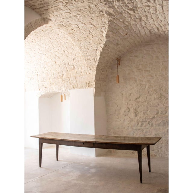 Long dining table with a beautiful oak top and its original patina. Recovered in France and dating back to the late...