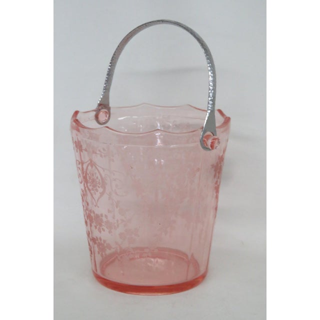 This beautiful Ice Bucket is made out of depression-era glass. Presenting a stunning pink color with an intricate floral...
