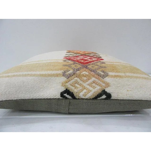 This is a pillow cover made from a vintage kilim rug. The piece was properly washed and ready to use. Pillow inserts not...