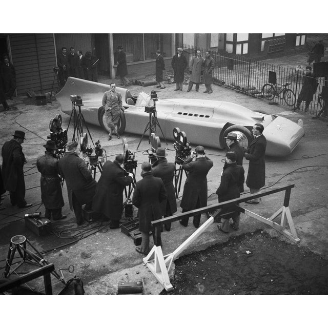 Bluebird 9th January 1935: Cameramen filming British racing driver Malcolm Campbell as he poses with a new Bluebird which...