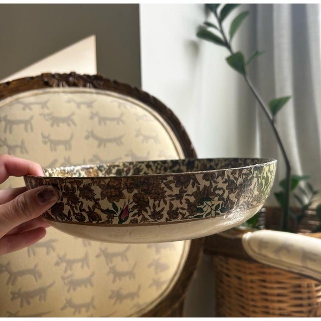 Traditional paper mache alcohol proof shallow bowl in floral print with metallic details. Multiple signs of wear and age....