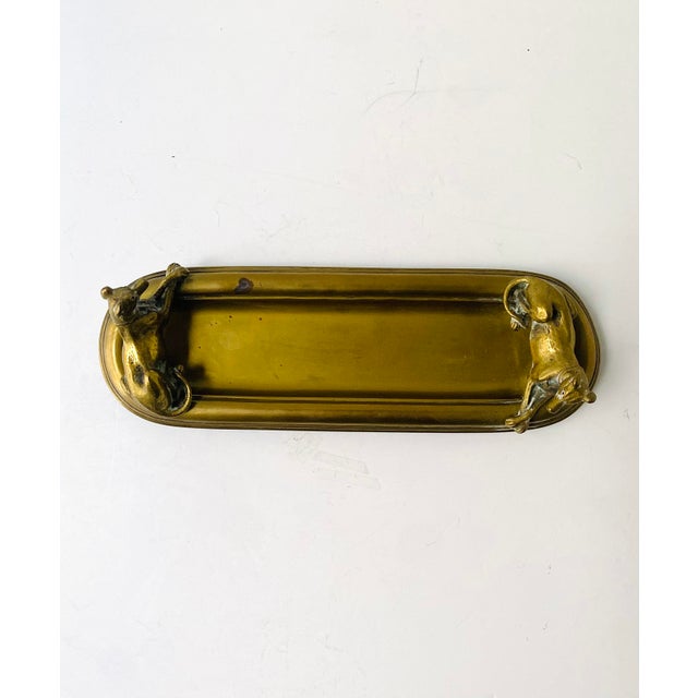 A solid brass catchall with two finely sculptured greyhound dogs at each end, Art Deco period, circa early 20th century,...