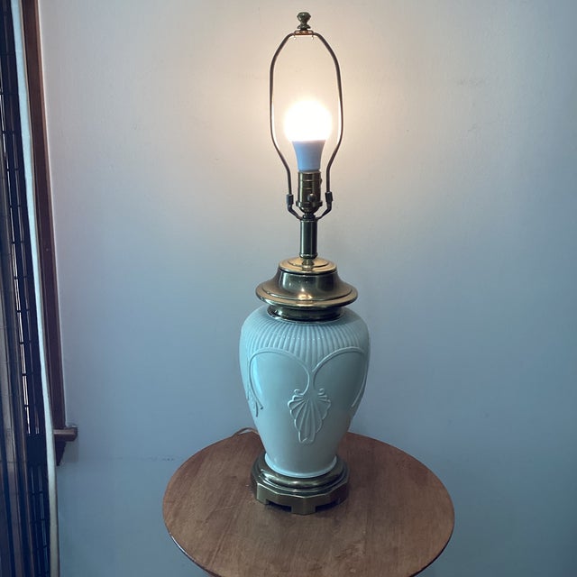 The Ivory Porcelain Embossed Leaf Design & Brass Lamp Footed Base by Ethan Allen is a vintage lamp with an original...