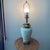 The Ivory Porcelain Embossed Leaf Design & Brass Lamp Footed Base by Ethan Allen is a vintage lamp with an original...