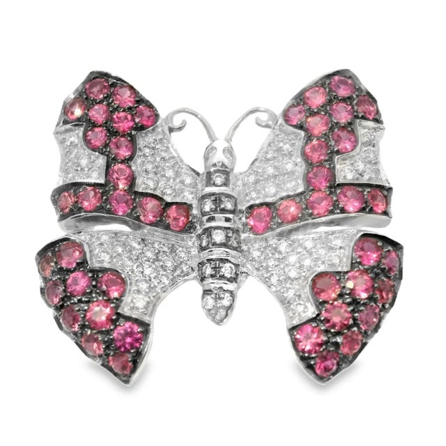 Estate 18K White Gold Ruby and Diamond Butterfly Brooch. This exquisite piece features 62 brilliant round diamonds and 48...