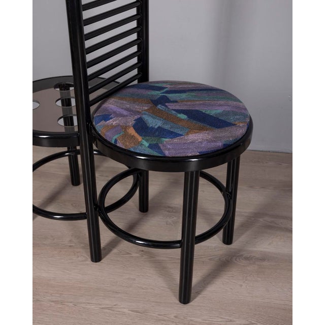 Entrance hall cabinet with black lacquered wooden frame, coat hooks, decorated fabric seat, and umbrella stand with smoked...