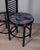Entrance hall cabinet with black lacquered wooden frame, coat hooks, decorated fabric seat, and umbrella stand with smoked...