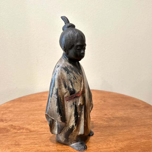 Well modeled, and with traces of gilt bronze the figure of a monk, perhaps a training monk - or Unsui, or if under ten...