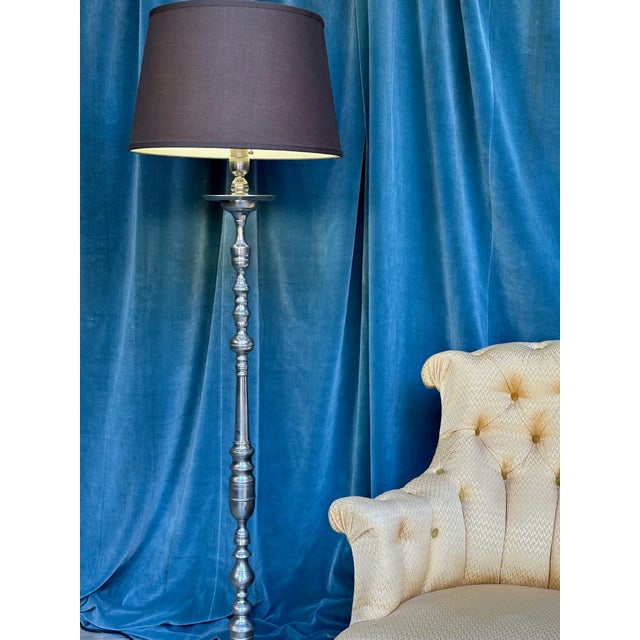 A stunning pair of French 1940s nickel plated floor lamps, featuring ornate stems made up of turned and cast bronze and...