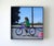 Traces captures a moment of childhood innocence as a young girl rides her bicycle, her expression a mix of concentration...