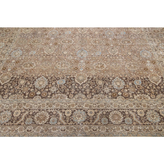 Beautiful antique Tabriz Persian hand-knotted wool rug with a gray color field. This piece has a designed frame with blue,...