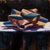 Gift of Copper presents a vibrant arrangement of geometric forms that appear to glow against a dark background. The artist...