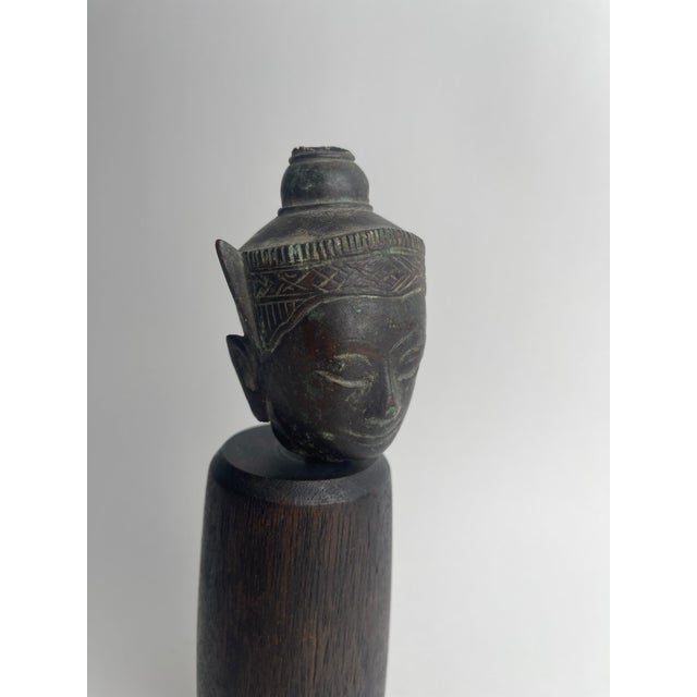This mid-to-late Ayutthaya period bronze Buddha head, dating from the 17th to 18th century, reflects the spiritual grace...