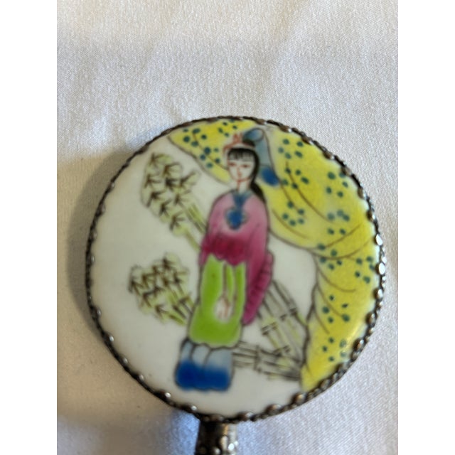 frame. The mirror surface displays a delicate hand-painted scene of a lady in traditional dress with bamboo. Perfect for...