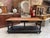 This antique oak draper's table has been fully restored. It features a waxed wooden top and a black-patinated base. The...