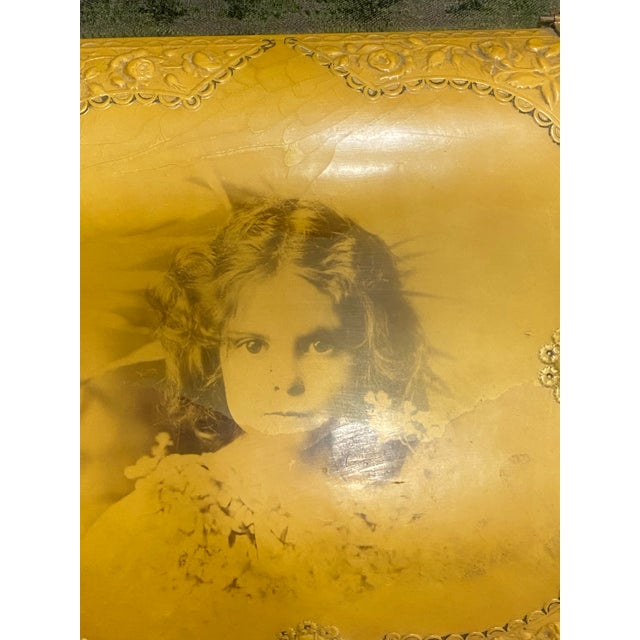 Antique early 20th-century celluloid vanity box featuring an embossed floral design and romantic portrait panel. Original...