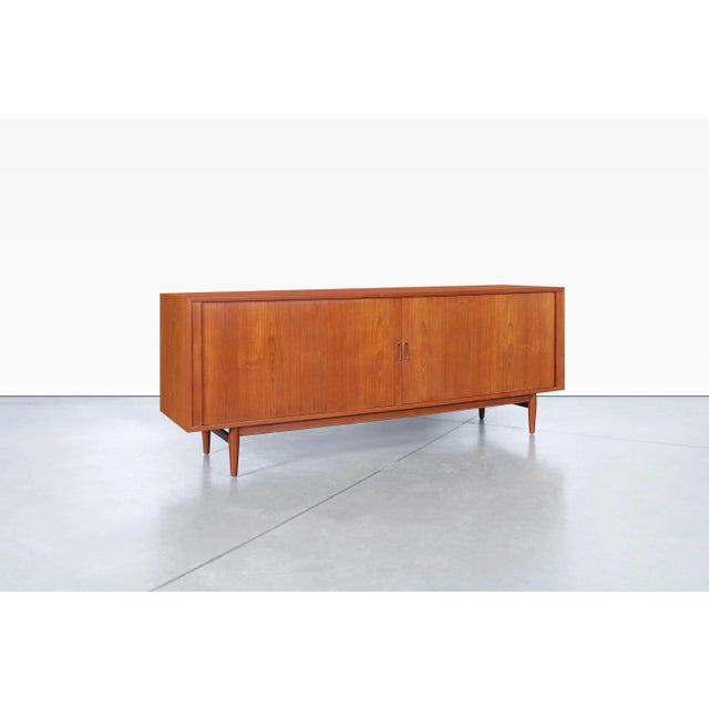 Danish modern teak tambour door credenza designed by Arne Vodder for Sibast in Denmark, circa 1950s. Model 37 exemplifies...