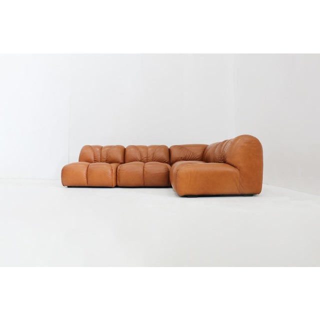 Vintage modular corner sofa in cognac leather designed in Italy in the 1970s. Sectional lounge sofa consisting of 4...