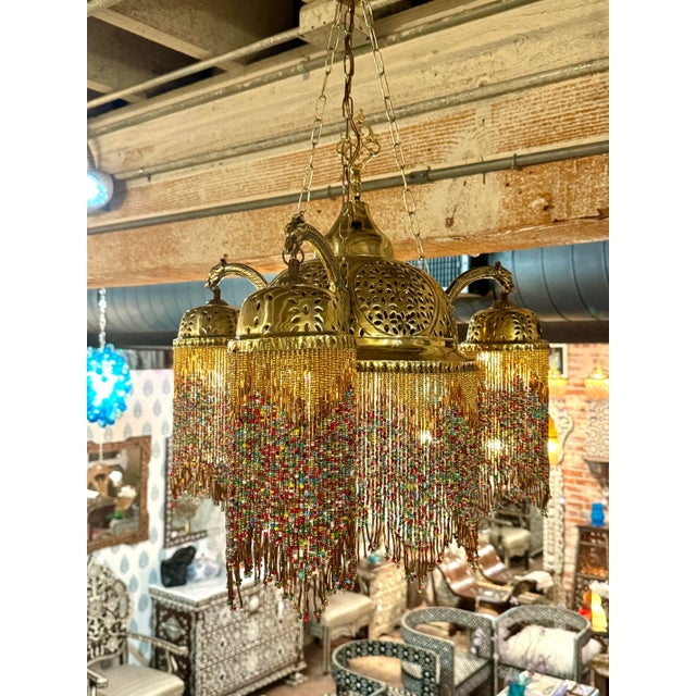 Vintage etched brass chandelier with glass beads. The brass hand etched using hammer and chisel on large dome style top...