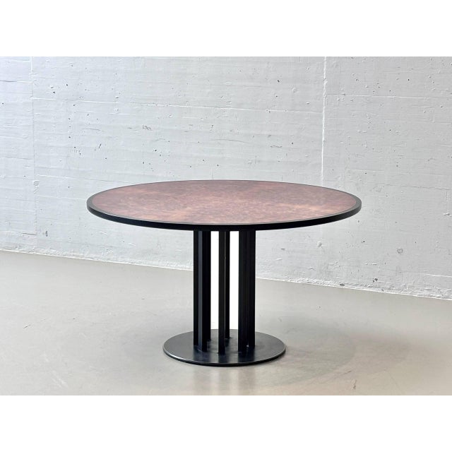 An elegant round designer table from the 1980s with an exceptional tabletop made of high-quality thuja root veneer. The...