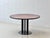 An elegant round designer table from the 1980s with an exceptional tabletop made of high-quality thuja root veneer. The...