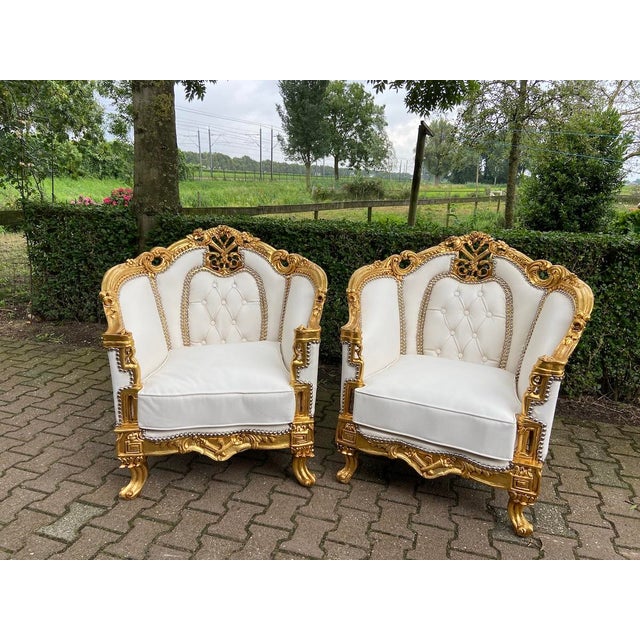 This impressive pair of 1950s Louis XVI–style bergère armchairs combines neoclassical French-inspired form with richly...