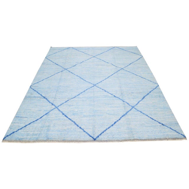 Moroccan hand knotted wool rug with abstract design.