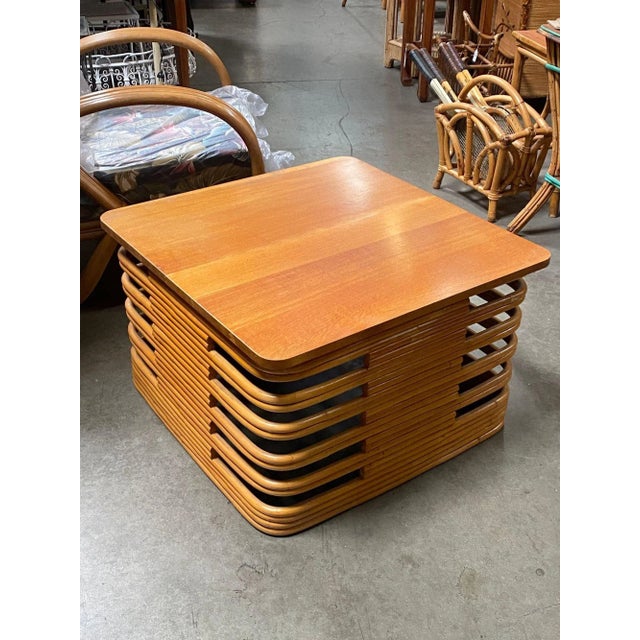 Vintage large 18.5" 1940s Rattan Coffee/Cocktail table with a round square stacked base, stylized cutout sides, and a...