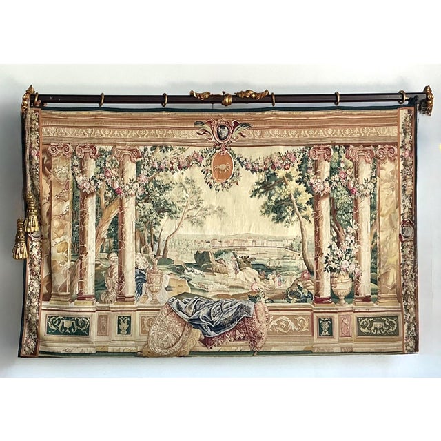 This impressive vintage tapestry from the celebrated Tenture des Maisons Royales series captures the stately romance of...