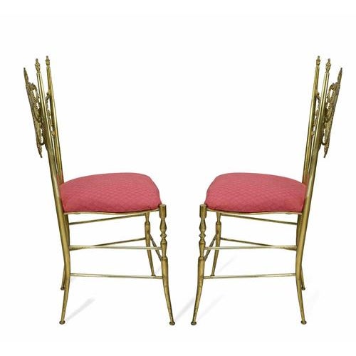 A refined set of two Italian modernist mahogany armchairs designed by Silvio Cavatorta, exemplifying the elegance and...